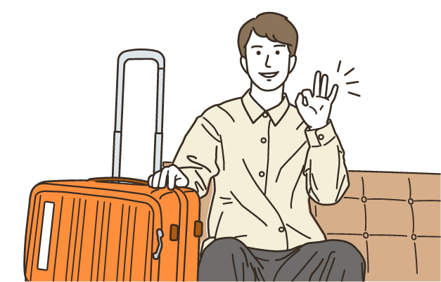 旅行の準備をしてOKポーズをする男性